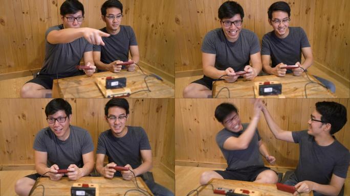 两名亚洲男子玩老式电子游戏