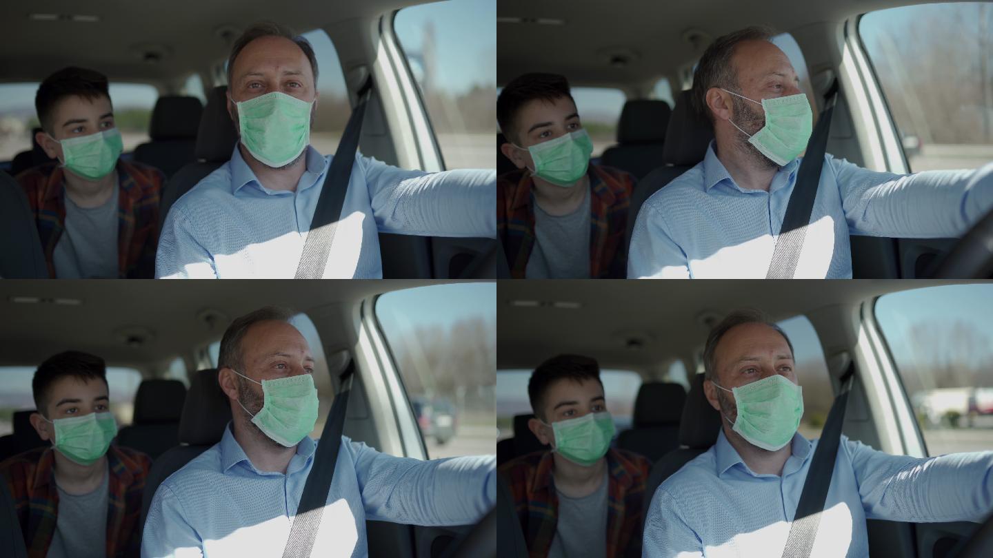 父亲和儿子戴着防护面具坐在车里