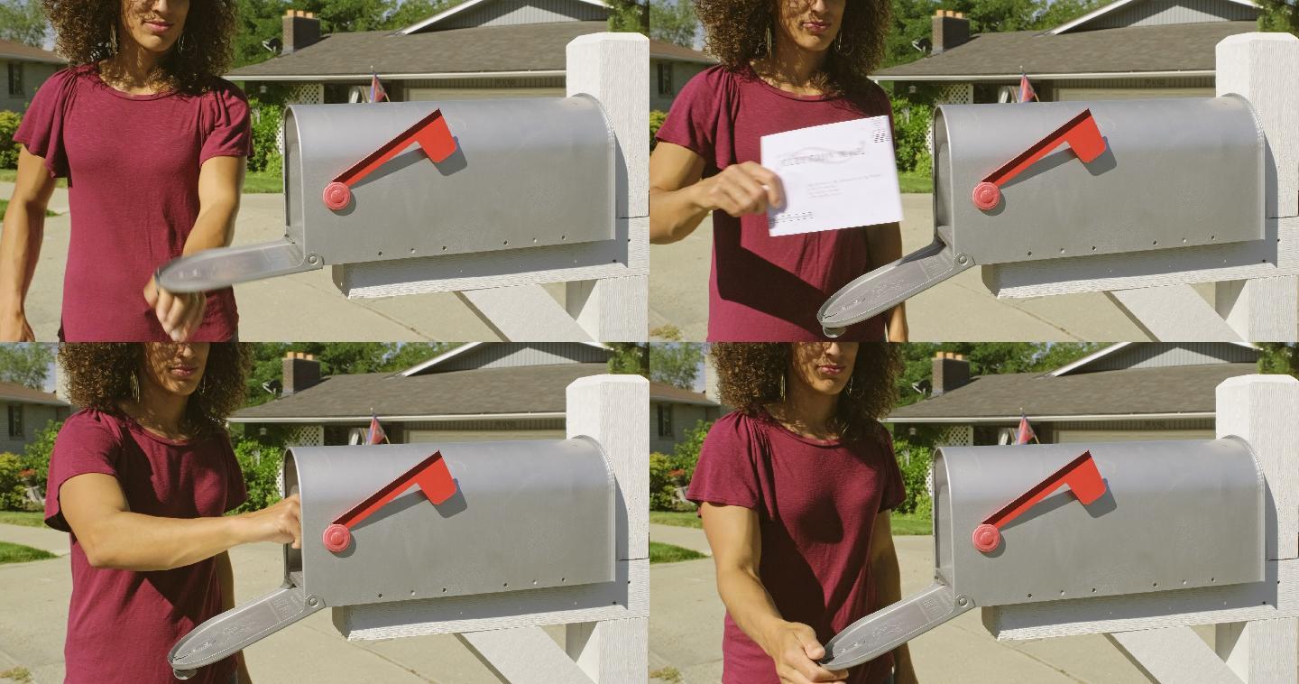 妇女把她的投票票放在一个家门口的邮箱里。