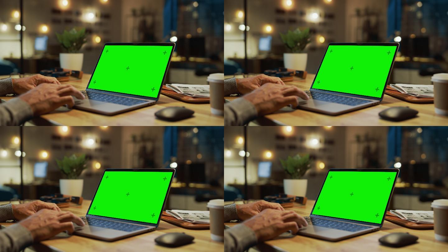 手上的特写镜头在一台模拟绿色屏幕的笔记本