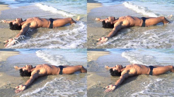 高清超慢镜头：躺在沙滩上的性感男人