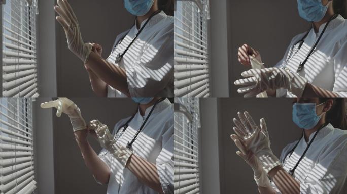 医务护士在窗边戴上医用手套。
