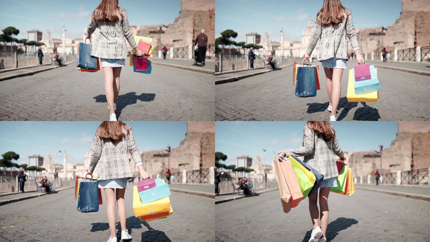 美丽的购物狂女孩带着购物袋漫步在米兰中心