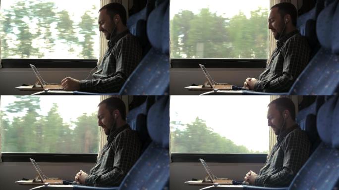 男人在火车上看电脑