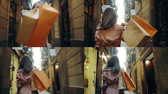 在城市街道上行走的购物妇女的后视图