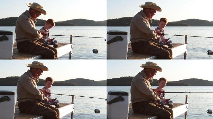 祖父和孙子在夏天日落时钓鱼