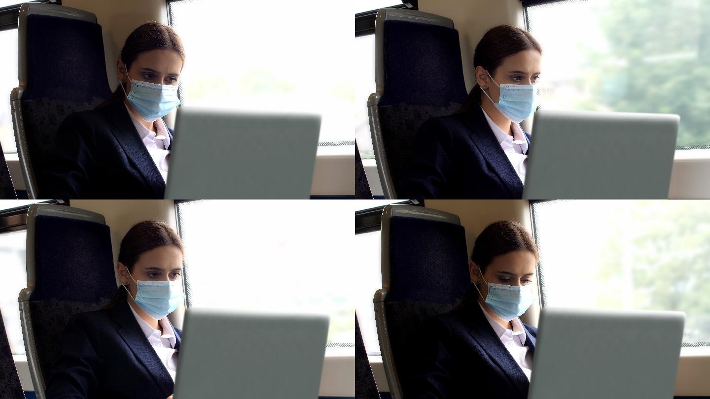 一个使用笔记本电脑在火车上工作的年轻女子