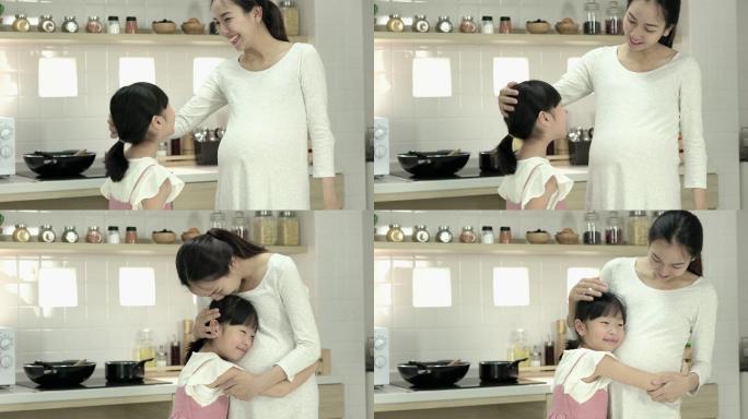 女儿和母亲拥抱二胎室内厨房妊娠期准妈妈