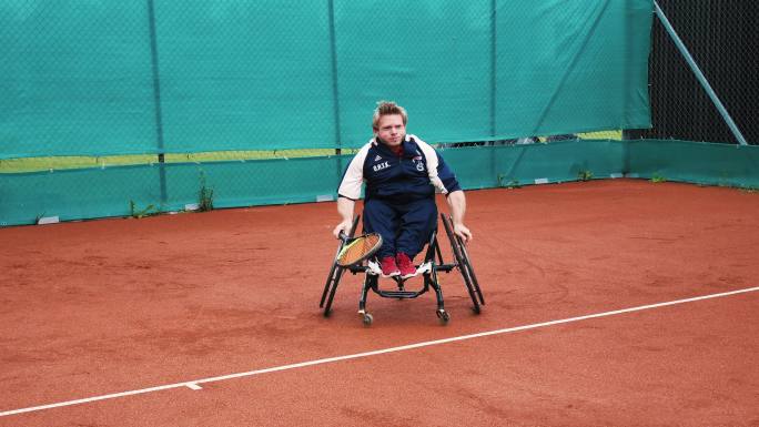 坐轮椅的男子打网球