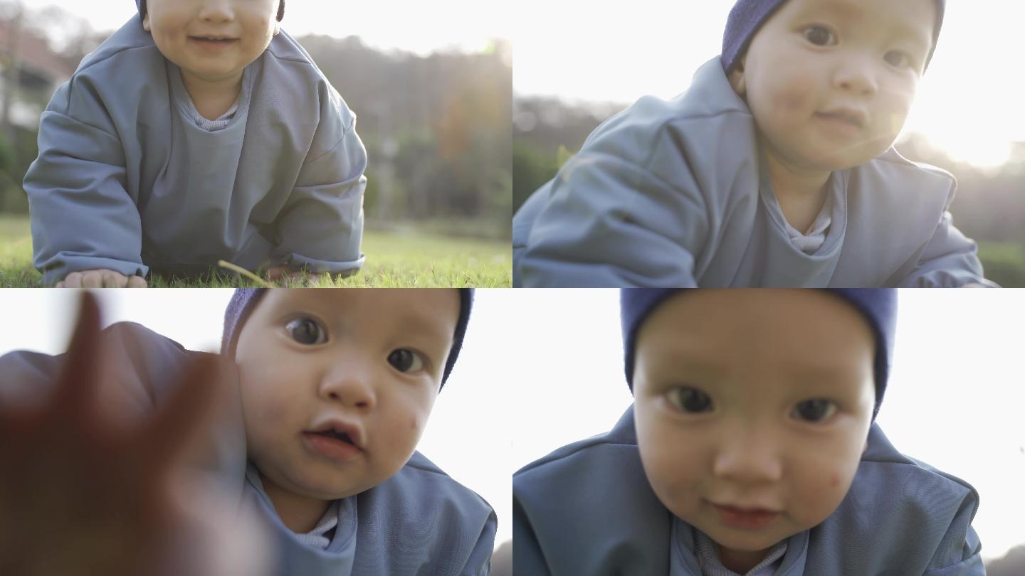 婴儿草地上爬特写，婴儿手触摸相机镜头