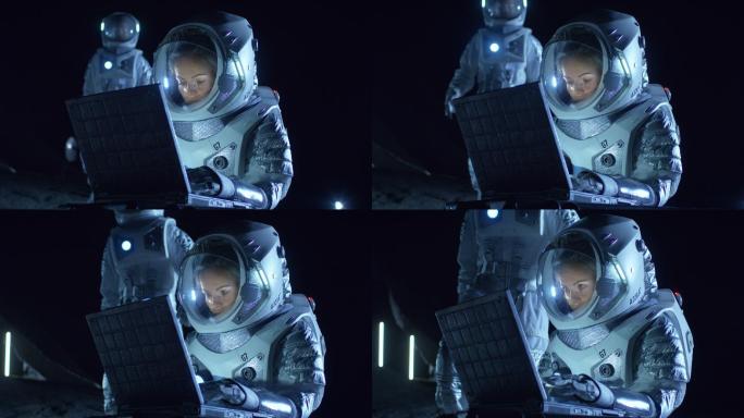 穿着宇航服的女宇航员在笔记本电脑上工作