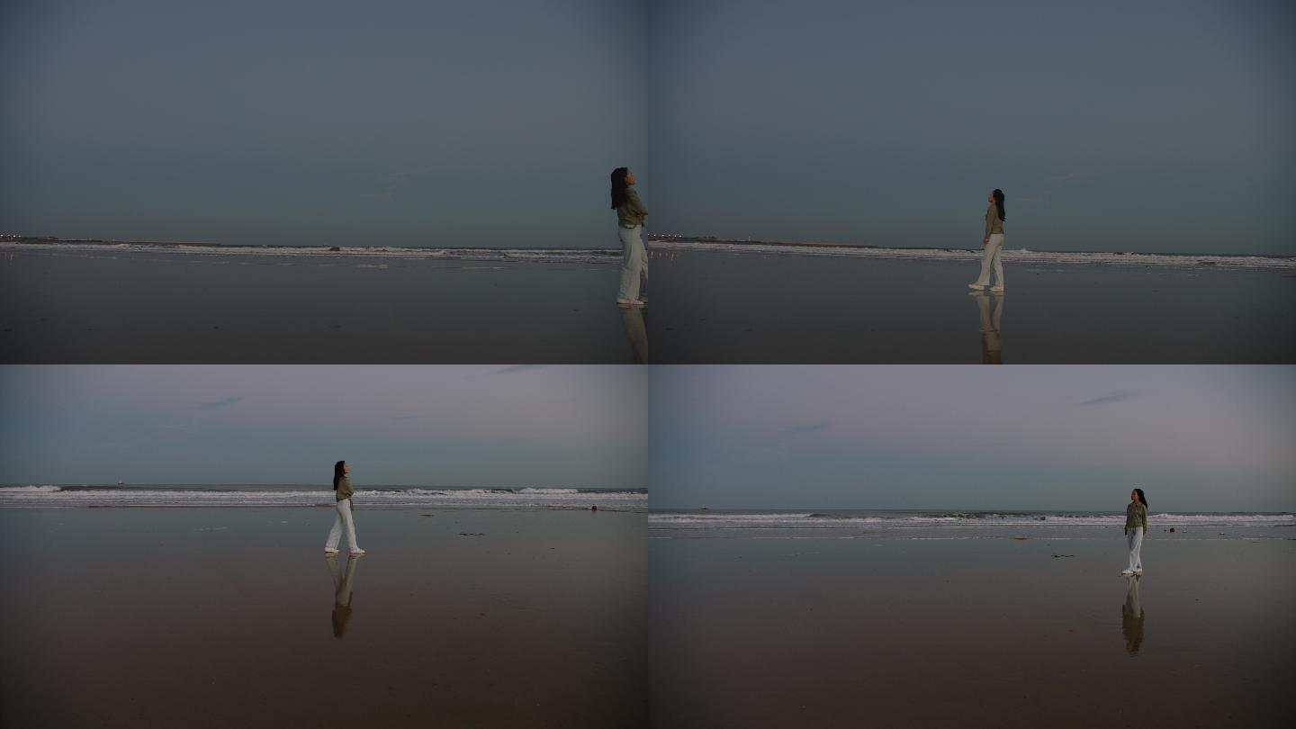 美女在海边孤独的行走