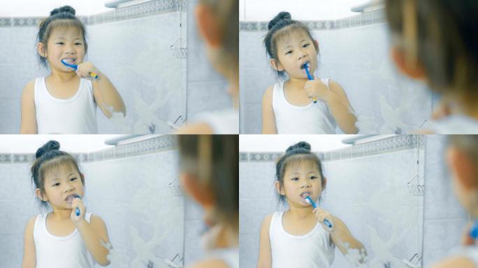 可爱的女孩在浴室刷牙