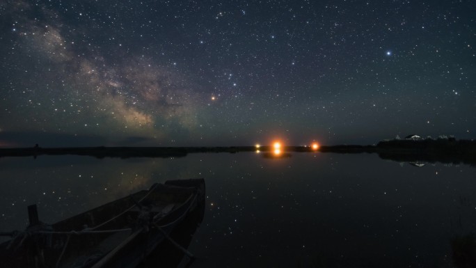 呼伦贝尔湖面小船映着星空倒影悠然飘荡