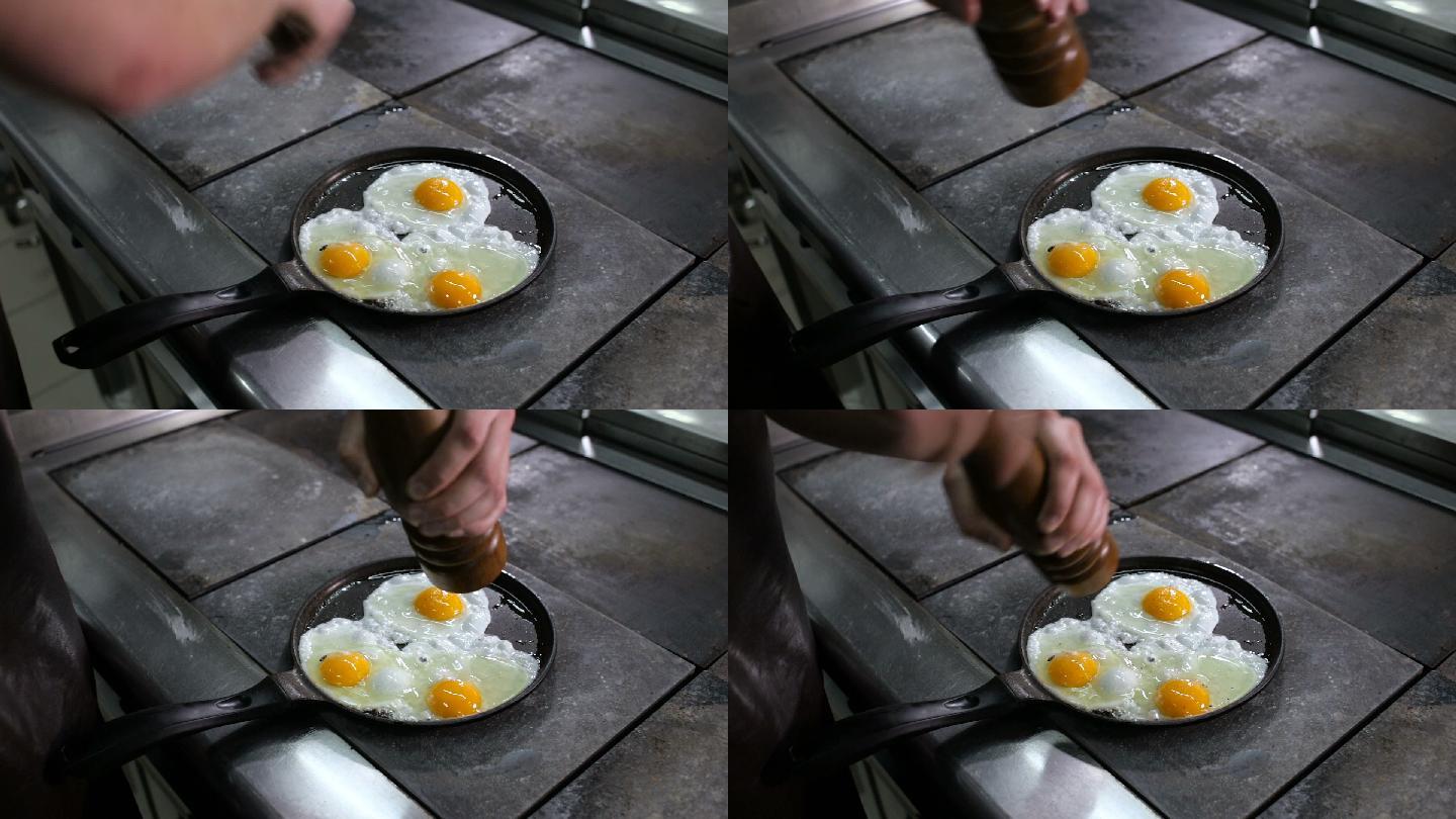 在煎锅里煎鸡蛋。早餐早点国外晚餐做饭做菜