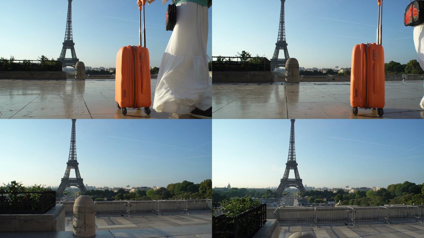 提着行李箱的年轻女子去巴黎旅行。