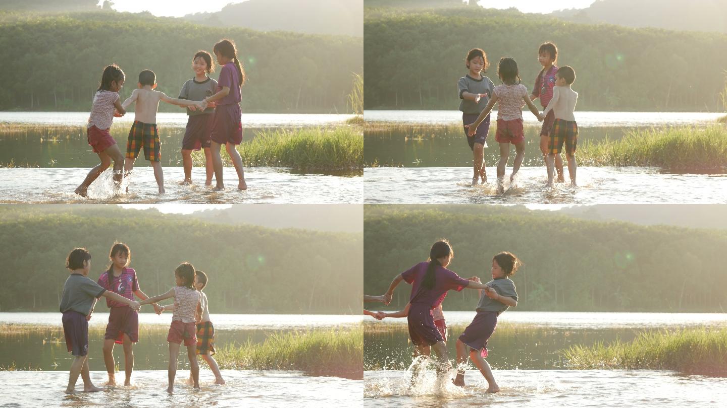 儿童在河里玩水小朋友河水河边拉手转圈