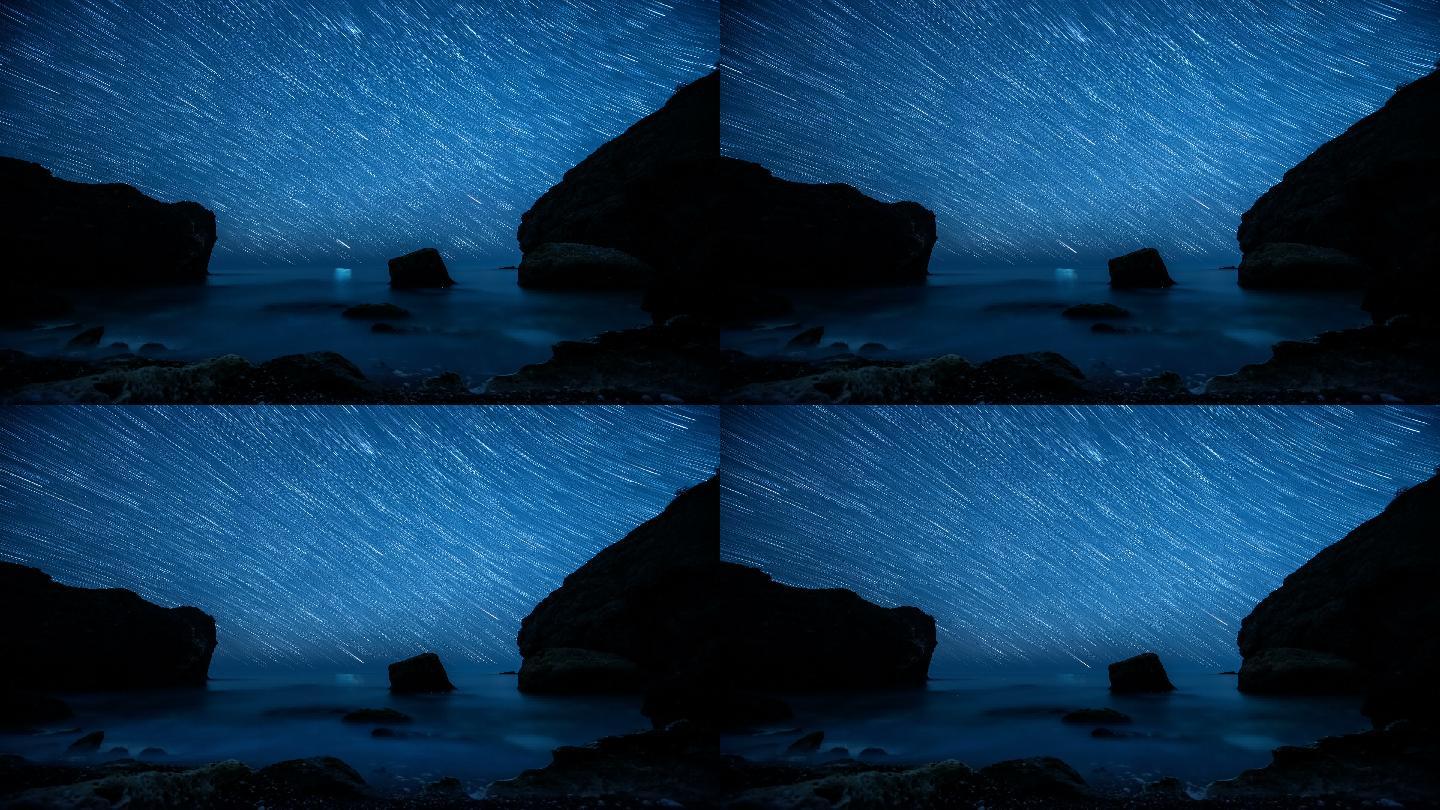 星星在多岩石的海岸上空划过。