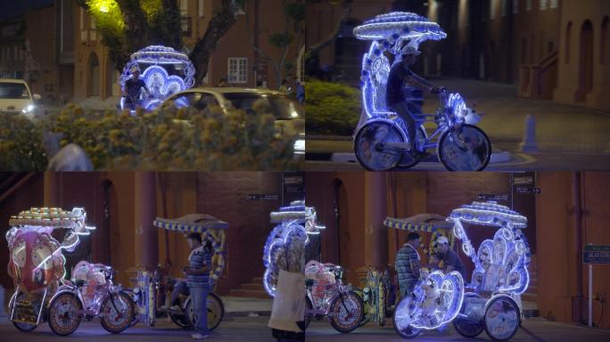 马六甲夜晚街道上的人力旅游三轮车
