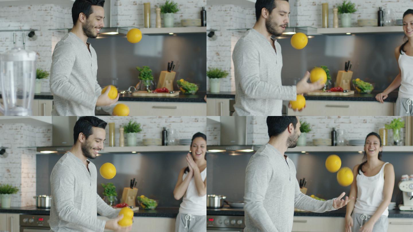 一个活泼的年轻人用厨房里的橙子杂耍