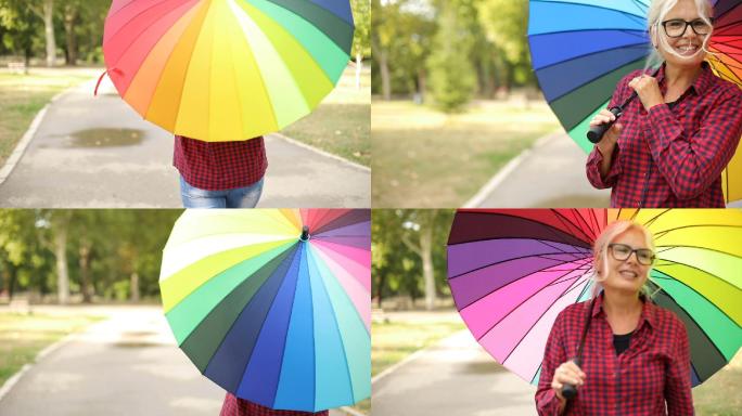 女人在户外打着彩色的伞