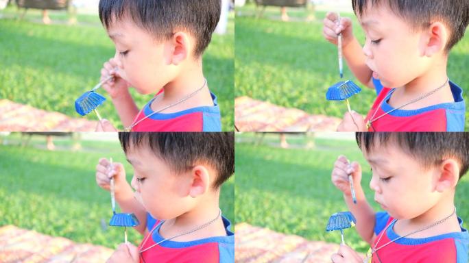 可爱的男孩在公园的草地上画石膏人像