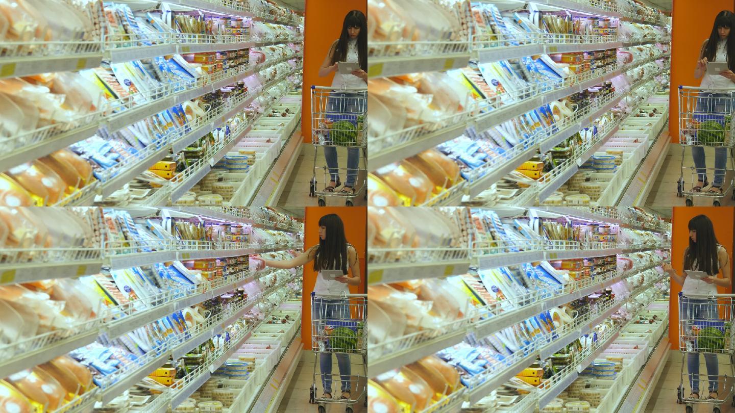 年轻女子推着购物车在超市购买冷藏食品