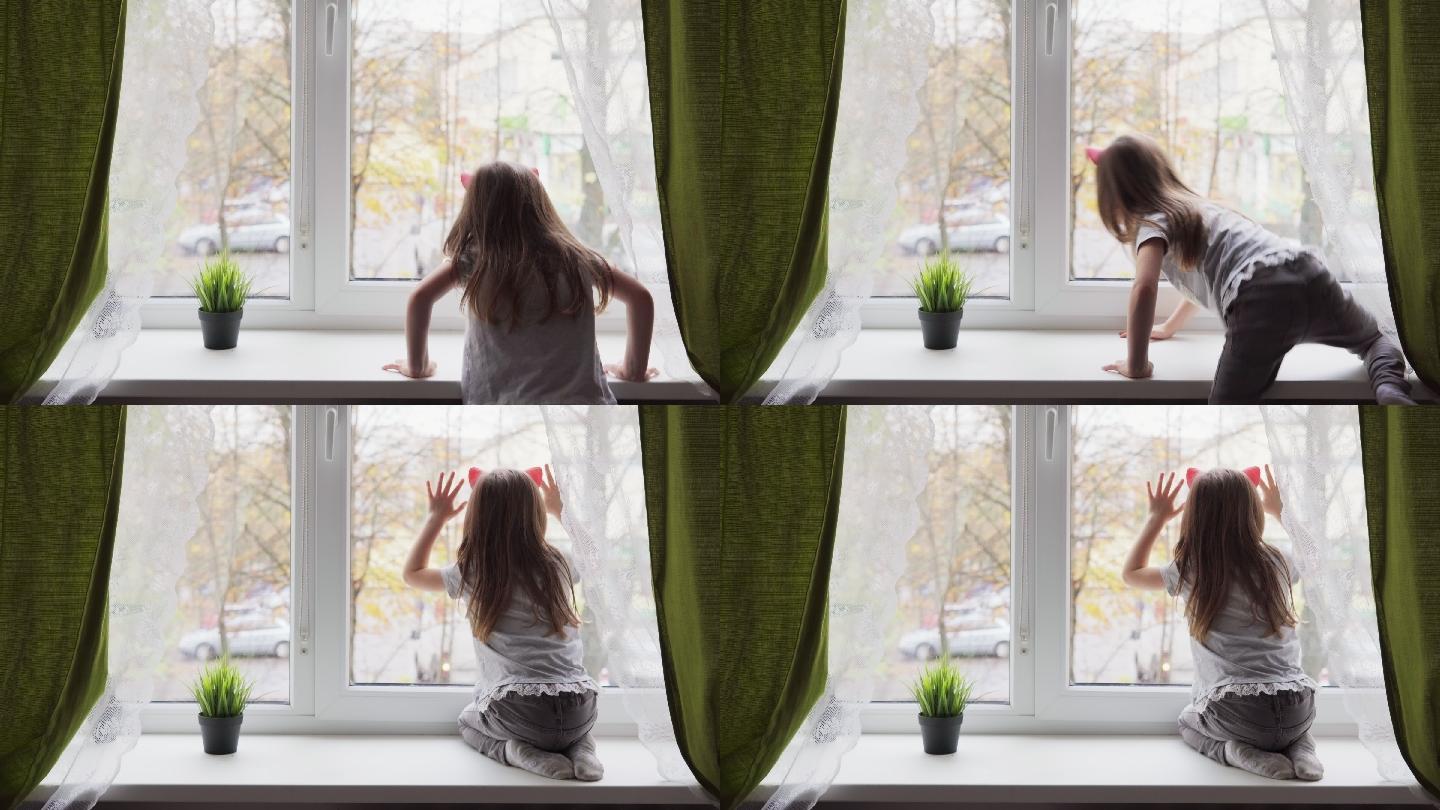 小女孩爬上窗台，望着窗外