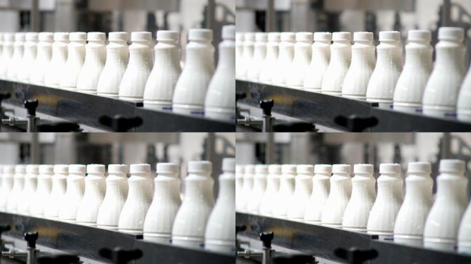 白色塑料奶瓶在生产线上分类和前进