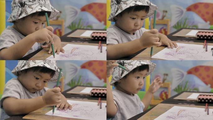 男孩在桌子上画画青少年儿童乱涂乱画启蒙阶