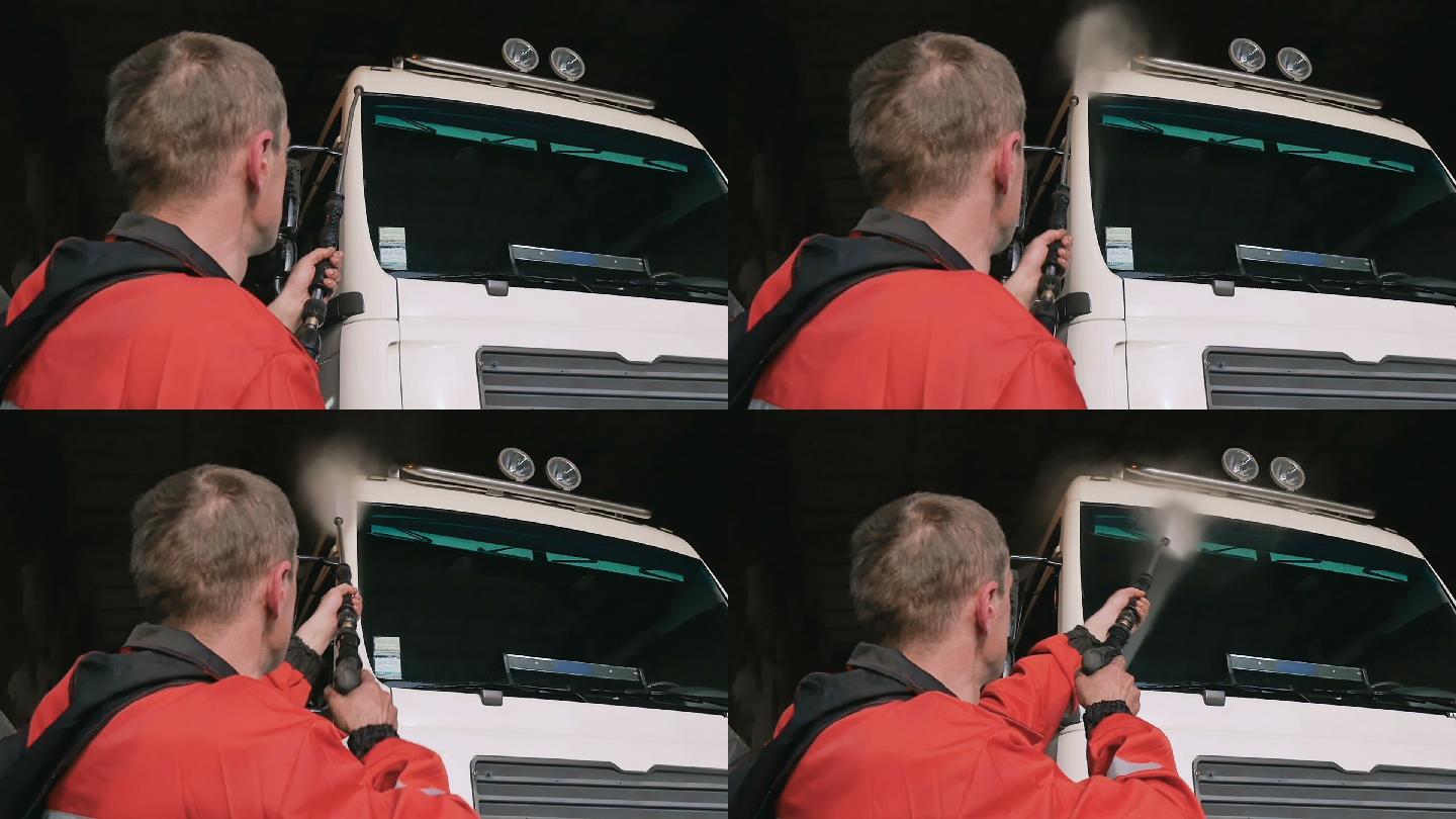 一名工人在清洗卡车的挡风玻璃