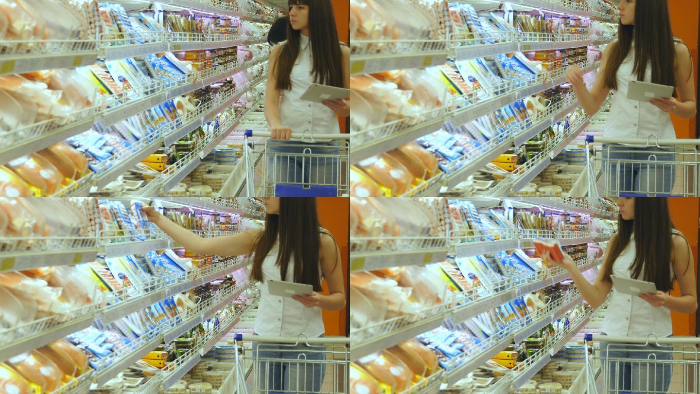 年轻女子推着购物车在超市购买冷藏食品