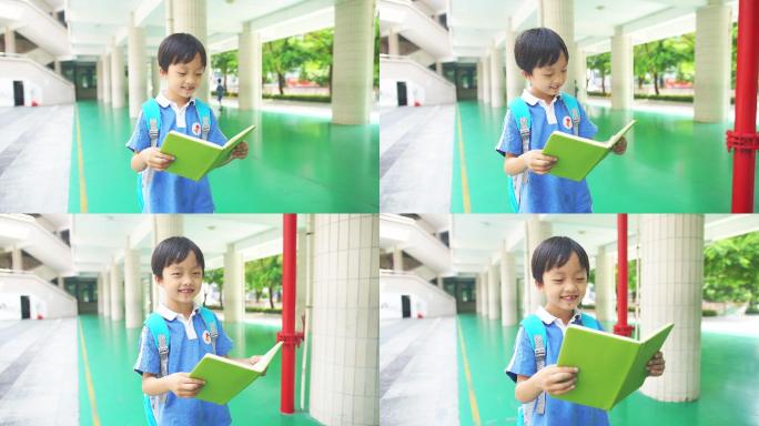 男孩走在学校里看书