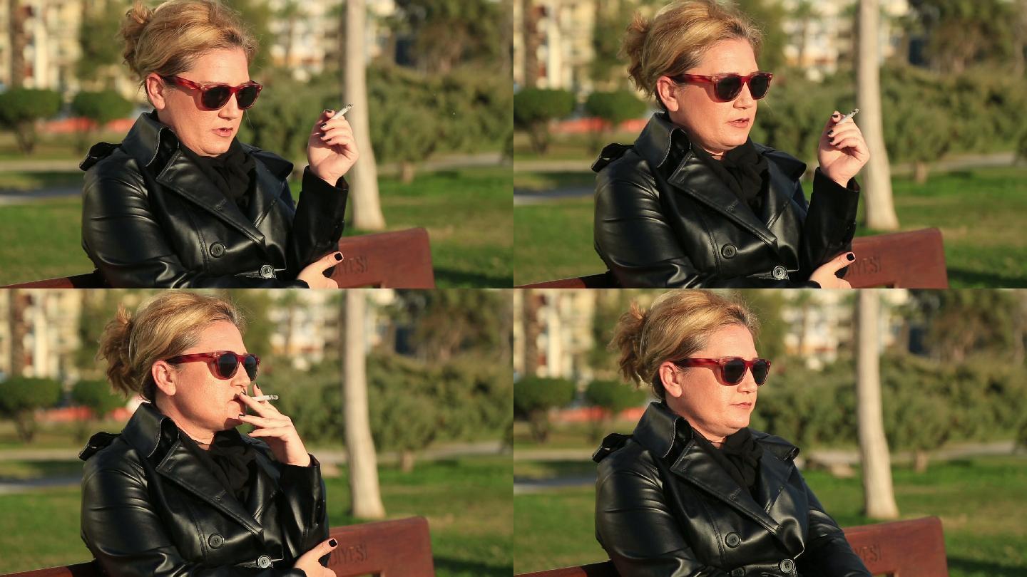 坐在公园长椅上抽烟的女人