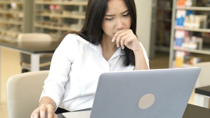 一名忧虑的女性使用笔记本电脑