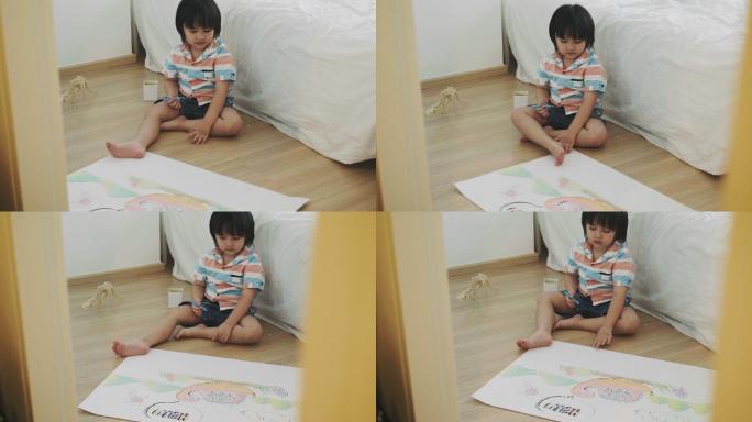 可爱的男孩正在画恐龙