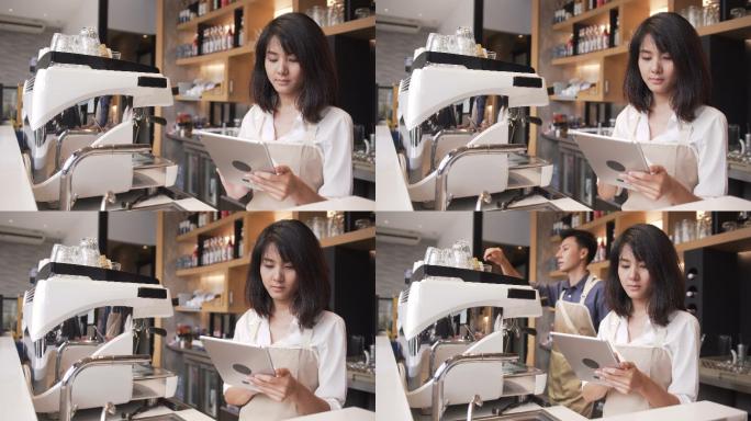 女咖啡师正在检查平板电脑里的咖啡订单