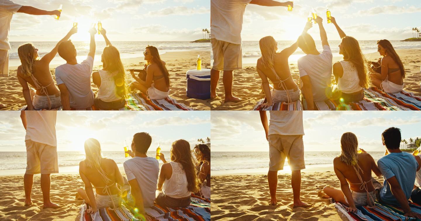 一群朋友在享受一个饮料和放松在日落的海滩上