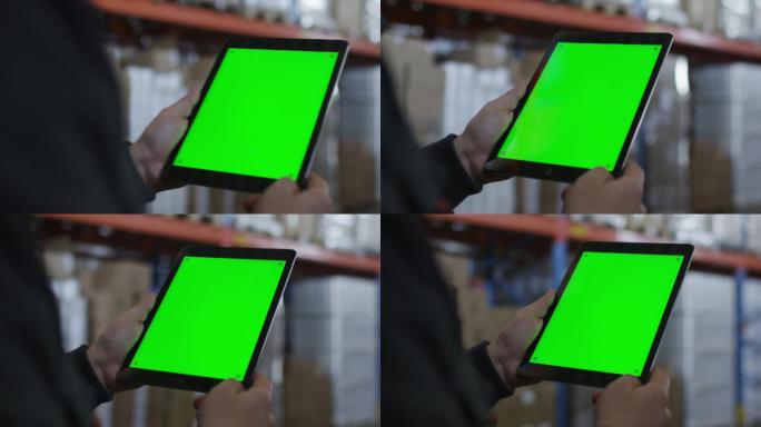 物流仓库工人手持绿屏平板行走