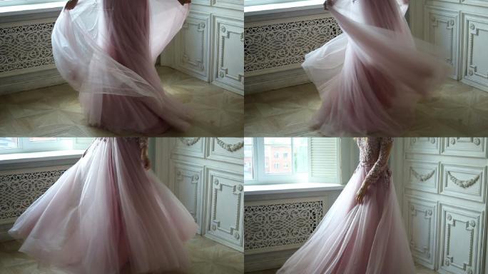 女孩穿着粉红色的蕾丝裙在房间里旋转