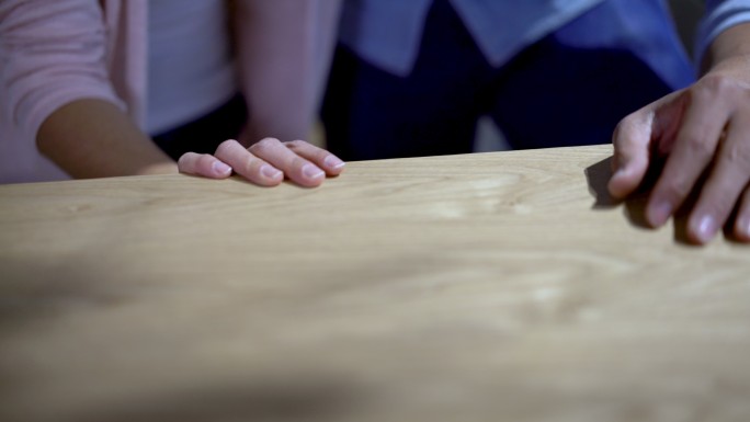 夫妇触摸一个木制餐桌