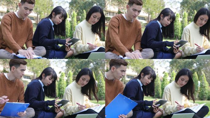 大学生在草地上一起读书