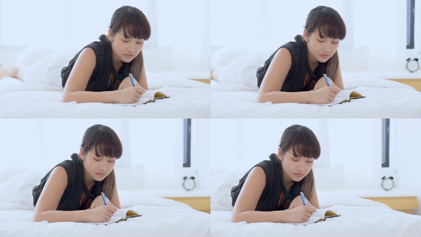 女子在床上写日记情愫懵懂悄悄心理青春期懵