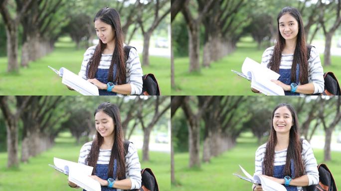 女孩在公园放松大学生看书的学生学习
