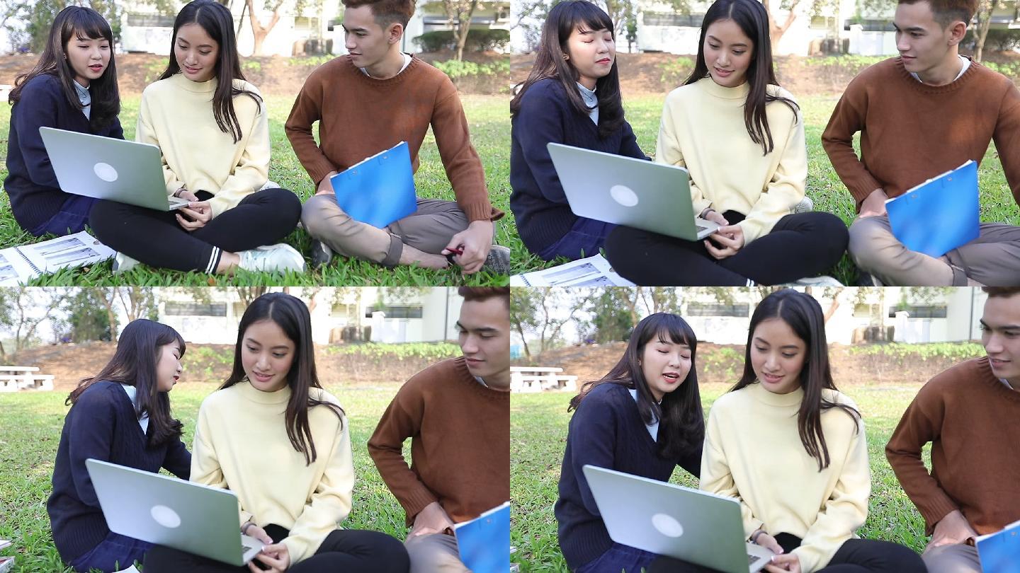 大学生坐在草地上阅读