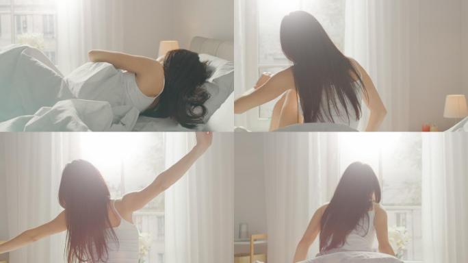美丽的黑发女人早上慢慢醒来，伸展身体