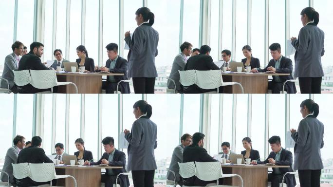 商务女性在会议期间向他的同事做演示
