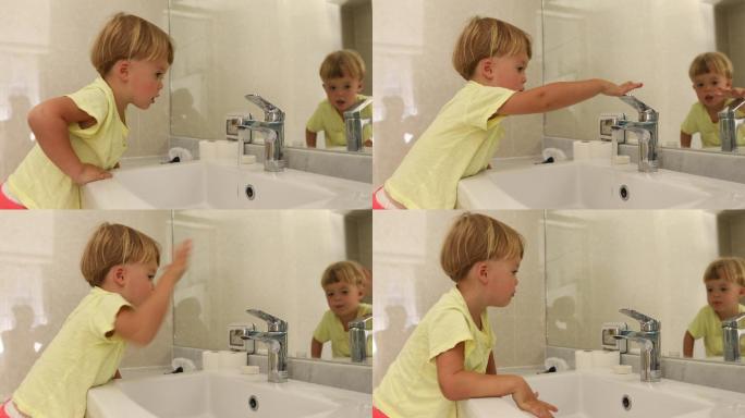 小男孩在浴室里关掉水龙头