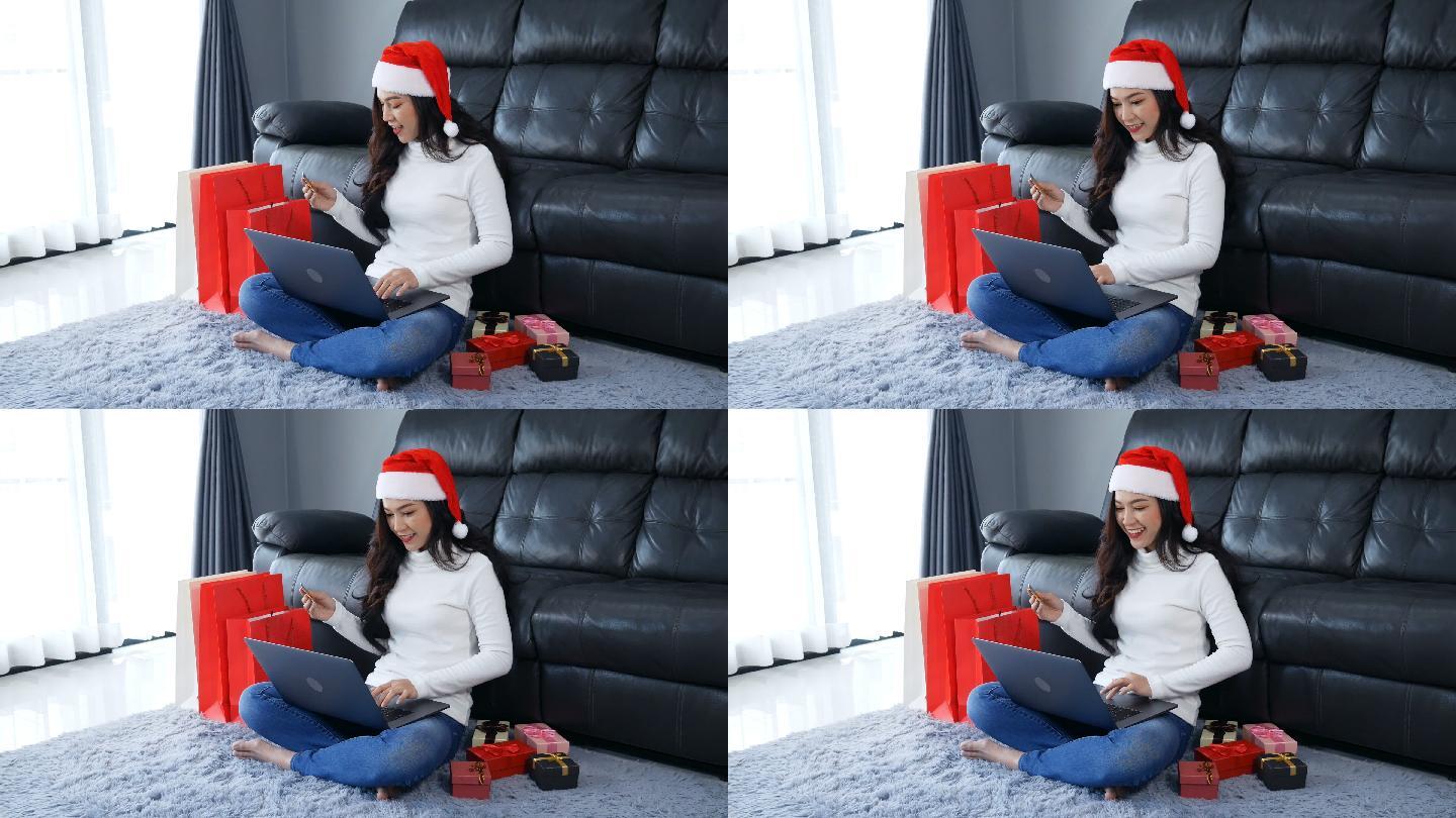 戴着圣诞帽在网上买圣诞礼物的女人
