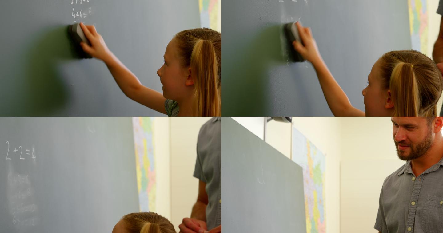 在擦黑板的小女孩国外教书环境抹布擦掉小女